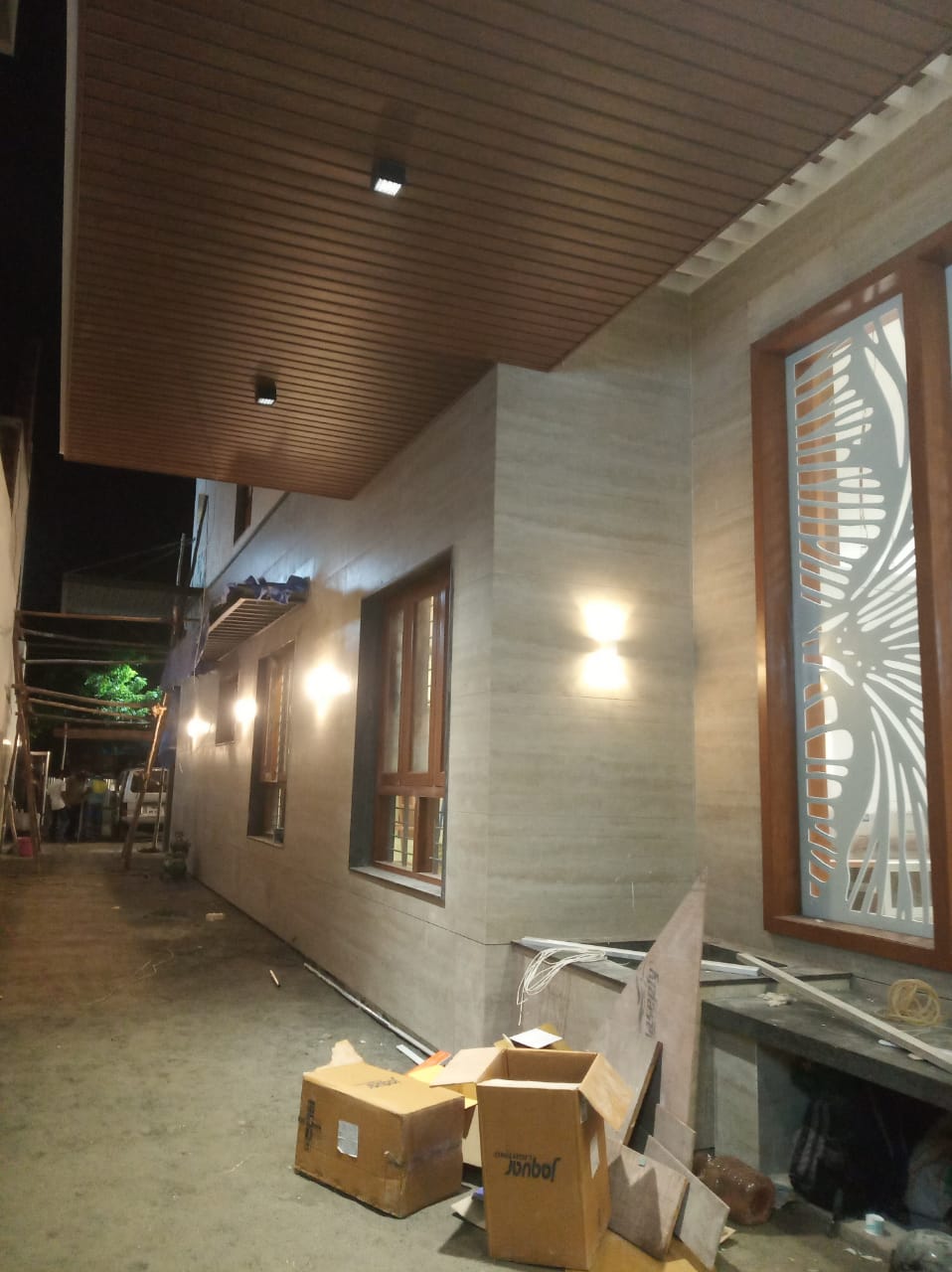 Portico exterior design with wood ceiling panel and window grill